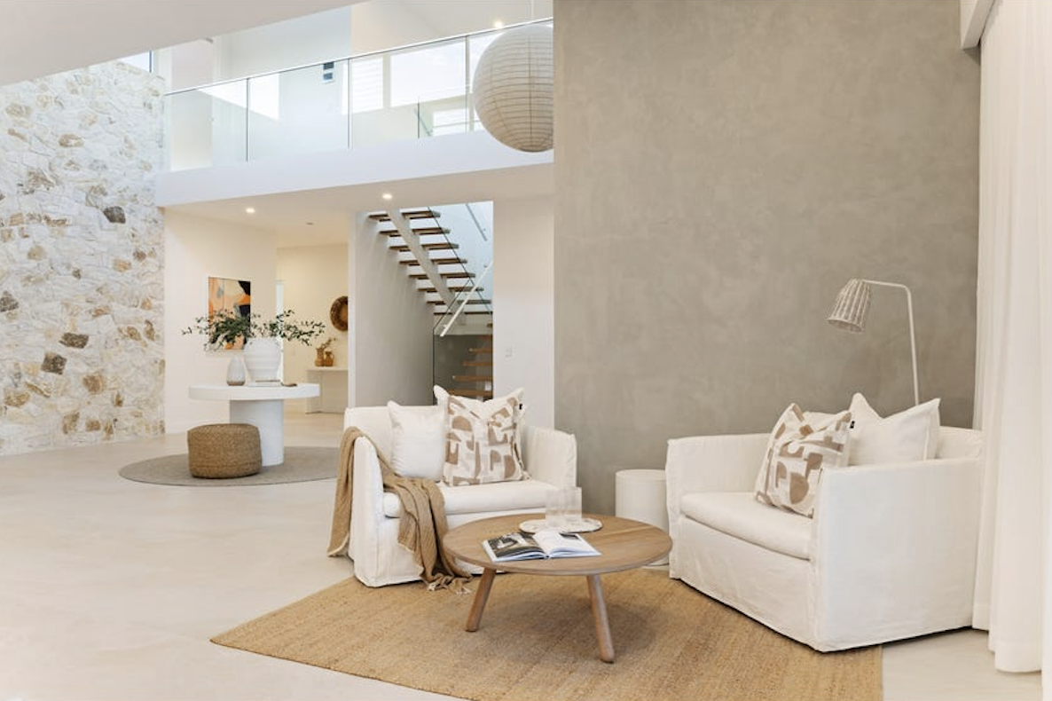coastal sitting area with warm timber and stone accents, property styling by blink living